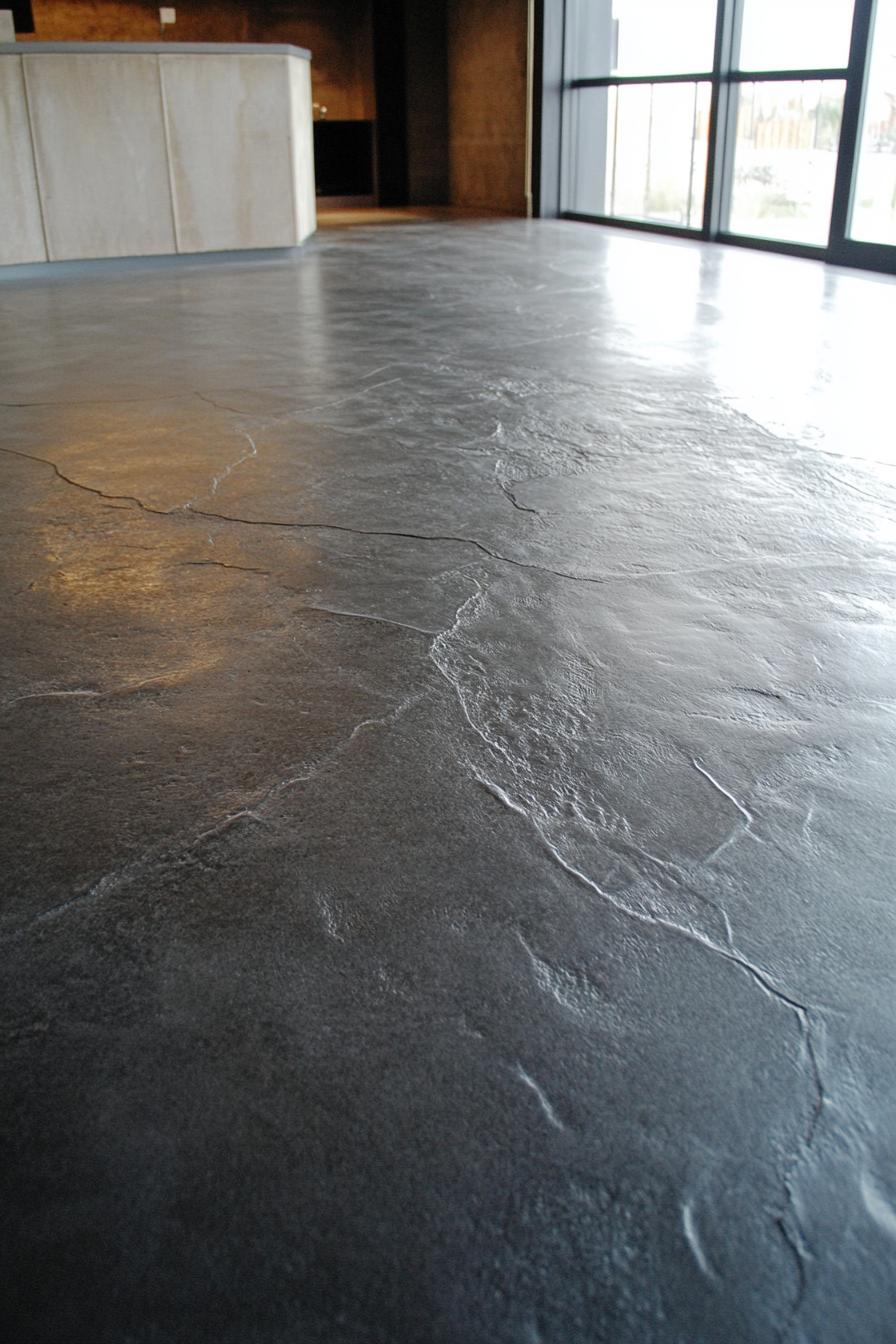 Smooth polished concrete floor in modern industrial interior with natural lighting.