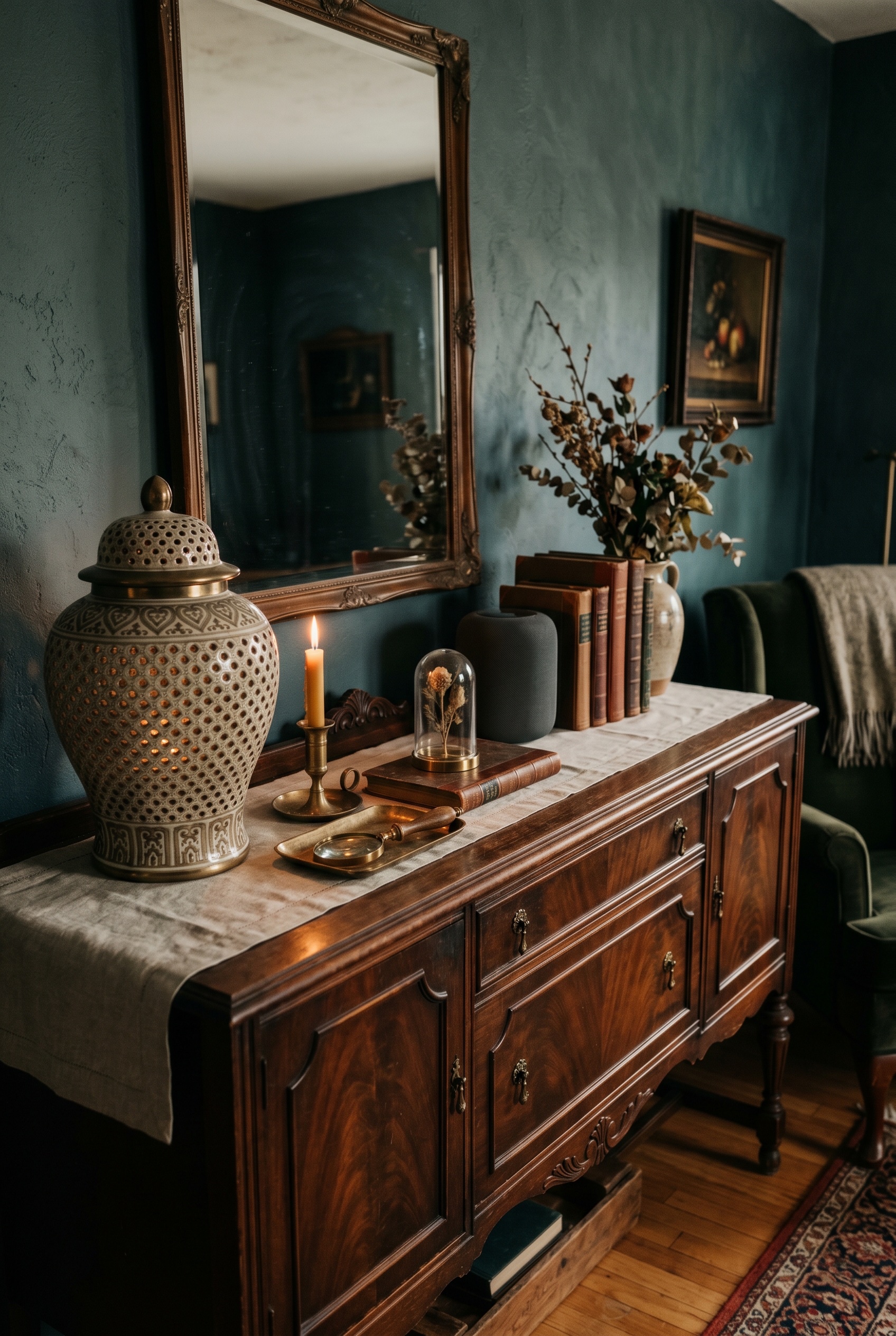 Photorealistic interior photo. A styled antique wooden credenza holding a perforated vintage ceramic ginger jar and brass accents. Hidden smart home tech aesthetic. Warm, moody interior lighting. Edit